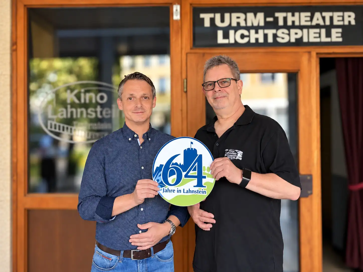 Wirtschaftsförderer der Stadt Lahnstein Christoph Noack überreicht Kino-Inhaber Thomas Birkelbach das Lahnstein-Label.